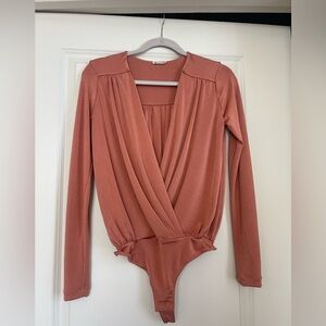 Free People long sleeve body suite open in the front